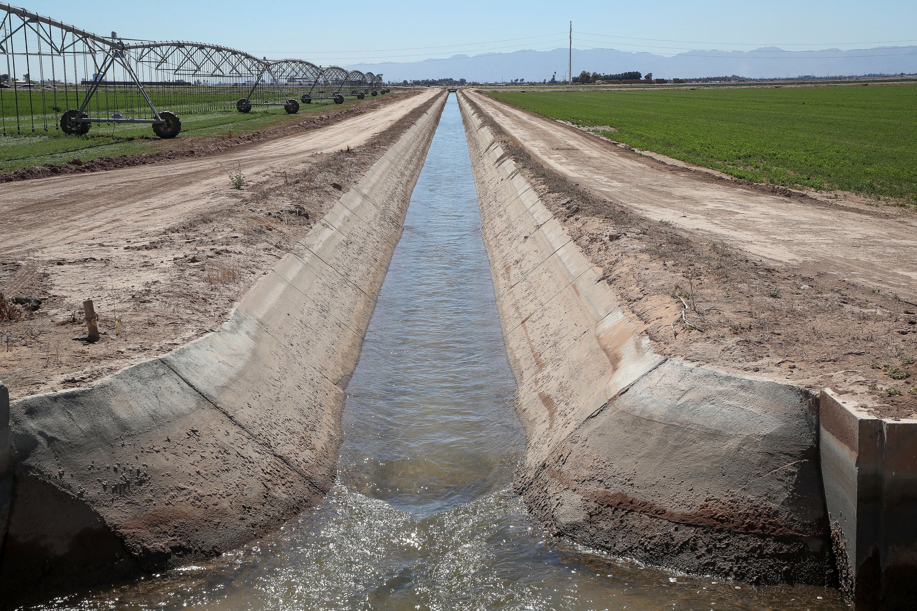 A canal transports water to farmland in the Imperial Valley, California.