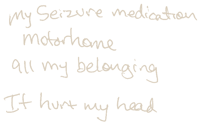 Handwritten card reading “My seizure medication motorhome all my belonging. It hurt my head”